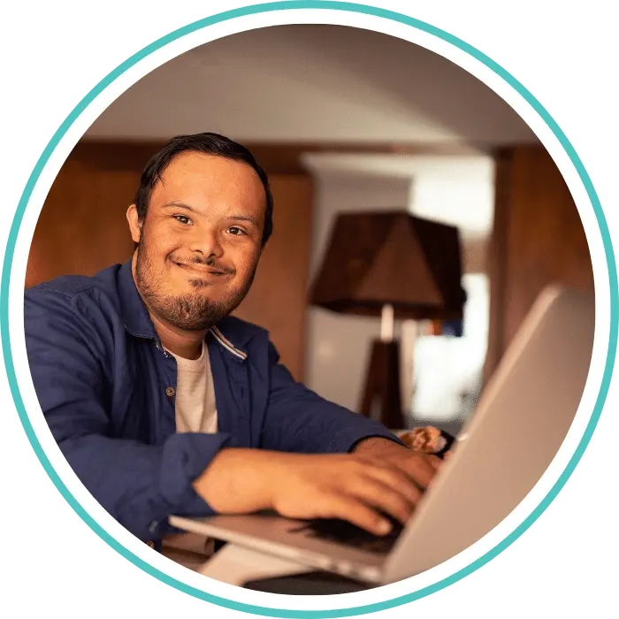 Disabled man with down syndrome using laptop